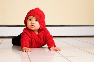 Toddler crawling on tile floor